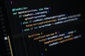 Close-up of Swift programming code on a computer screen showing mobile app interface structure