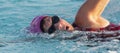 Close up of a swimmers face as she takes a breath while swimming laps in a pool Royalty Free Stock Photo