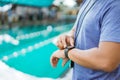 close up of a swimming coach& x27;s hand holding a watch