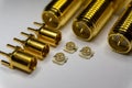 Close-up of symmetric aligned gold plated uFL, MMCX micro precision radio connector partial focus white SMA background