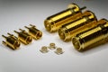 Close-up of symmetric aligned gold plated uFL, MMCX micro precision radio connector partial focus white SMA background