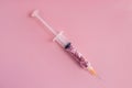 Syringe a full of sugar isolated on pink. Concept of diabetes.