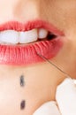 Close up of syringe injecting botox into female lips.