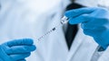 Close up. syringe with a new vaccine in the hands of a medic.