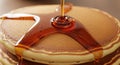 Close up of syrup being poured on a stack of pancakes creating a delicious breakfast treat image Royalty Free Stock Photo