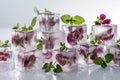 A close up of a table with a bunch of ice cubes and flowers. edible flower Royalty Free Stock Photo