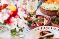 Close up of table full of fresh seasonal healthy food for group of people - lunch or brunch background coloured composition