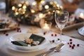 A close-up of table set for dinner meal at Christmas time. Royalty Free Stock Photo