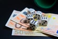 Some six-sided dice on some 50 euro bills with copy space Royalty Free Stock Photo