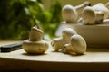 Common mushrooms (Agaricus bisporus) on a kitchen board with parsley in the background Royalty Free Stock Photo