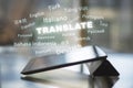 Close up of tablet with abstract text on blurry background. Translation, foreign language, service and education concept. Double Royalty Free Stock Photo