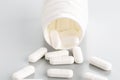 A close-up of a tablet bottle with a few white antibiotic pills Royalty Free Stock Photo