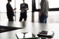 Close up of tablet, business people on meeting in background Royalty Free Stock Photo