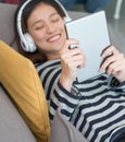 Close up on tablet computer with teenage girl enjoying listening