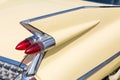 Close-up of tail light and rear part of retro car. Detail of vintage classic vehicle. Wing fender with chrome bumper and red brake