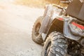 Close-up tail view of ATV quad bike. Dirty whell of AWD all-terrain vehicle. Travel and adventure concept.Copyspace.Toned Royalty Free Stock Photo