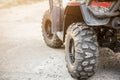 Close-up tail view of ATV quad bike. Dirty whell of AWD all-terrain vehicle. Travel and adventure concept.Copyspace.Toned