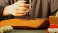 A close-up tailor makes a neat high-quality seam on the element of a leather product using a sewing machine. Slow motion