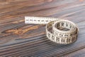 Close up tailor measuring tape on wooden table background. White measuring tape shallow dept of field