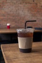Close up of take away plastic cup of iced black coffee