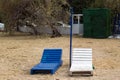 Empty wooden beach chaise longue in blue and white colors with umbrella bar at beach Royalty Free Stock Photo