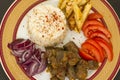 Traditional Turkish roast beef liver designed in stylish plate with fried potato,tomato,onion and rice on plate