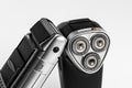 Two different shavers leaning each other on white background Royalty Free Stock Photo