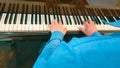 Close up Talent and virtuosity back view of man pianist hands on a grand piano keyboard