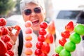 Close-up of Tanghulu Strawberry candies coated in clear and crispy sugar glaze, Candy strawberry sweet with blurred traveler,