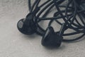 Close-Up Of Tangled Earphones On CConcrete Background