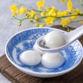 Close up of tangyuan in a bowl on gray table, food for Winter Solstice