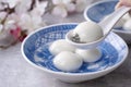 Close up of tangyuan yuanxiao in a bowl on gray table, food for Winter Solstice