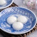 Close up of tangyuan yuanxiao in a bowl on gray table, food for Winter Solstice