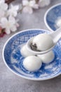 Close up of tangyuan yuanxiao in a bowl on gray table, food for Winter Solstice