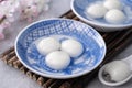 Close up of tangyuan yuanxiao in a bowl on gray table, food for Winter Solstice