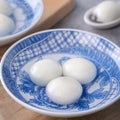 Close up of tangyuan yuanxiao in a bowl on gray table, food for Winter Solstice