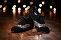 close-up of tap shoes on a black dance floor