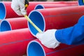 Close-up, tape measures for measuring the diameter of plastic red pipes, for laying electrical cables Royalty Free Stock Photo