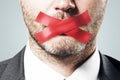 Close up of taped european businessman mouth.