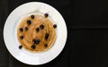 Close up of a tasty american pancake with blueberries and maple syrup