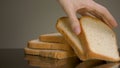 Close up of tasty baked bread slices with crispy crust lying on reflective surface isolated on grey background. Stock Royalty Free Stock Photo