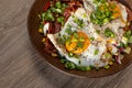 Close up tasty, delicious and greasy fried eggs with meat and bacon. Food delivery and fast food service for busy people Royalty Free Stock Photo