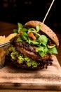 close-up of tasty double hamburger with fresh green lettuce and spinach Royalty Free Stock Photo