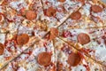 Close Up of Tasty Hot Pizza with Bacon, pepperoni sausage, ham, mozzarella cheese, sweet pepper, herbs, red onion. Food to order Royalty Free Stock Photo