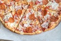 Close Up of Tasty Hot Pizza with Bacon, pepperoni sausage, ham, mozzarella cheese, sweet pepper, herbs, red onion. Food to order Royalty Free Stock Photo