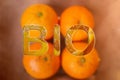 Close up of tasty orange fruits background and BIO text. Fresh orange peel, healthy organic food concept