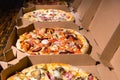 Close up of tasty pizzas with variety of toppings and cheese in Royalty Free Stock Photo