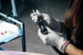 Tattooist woman making tattoo