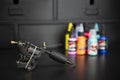 Close up of tattoo machine with colored ink bottles on a dark background. Tattoo studio set Royalty Free Stock Photo
