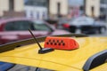 Close-up of taxi sign, symbol on car. Abstract traffic. Urban blurred background